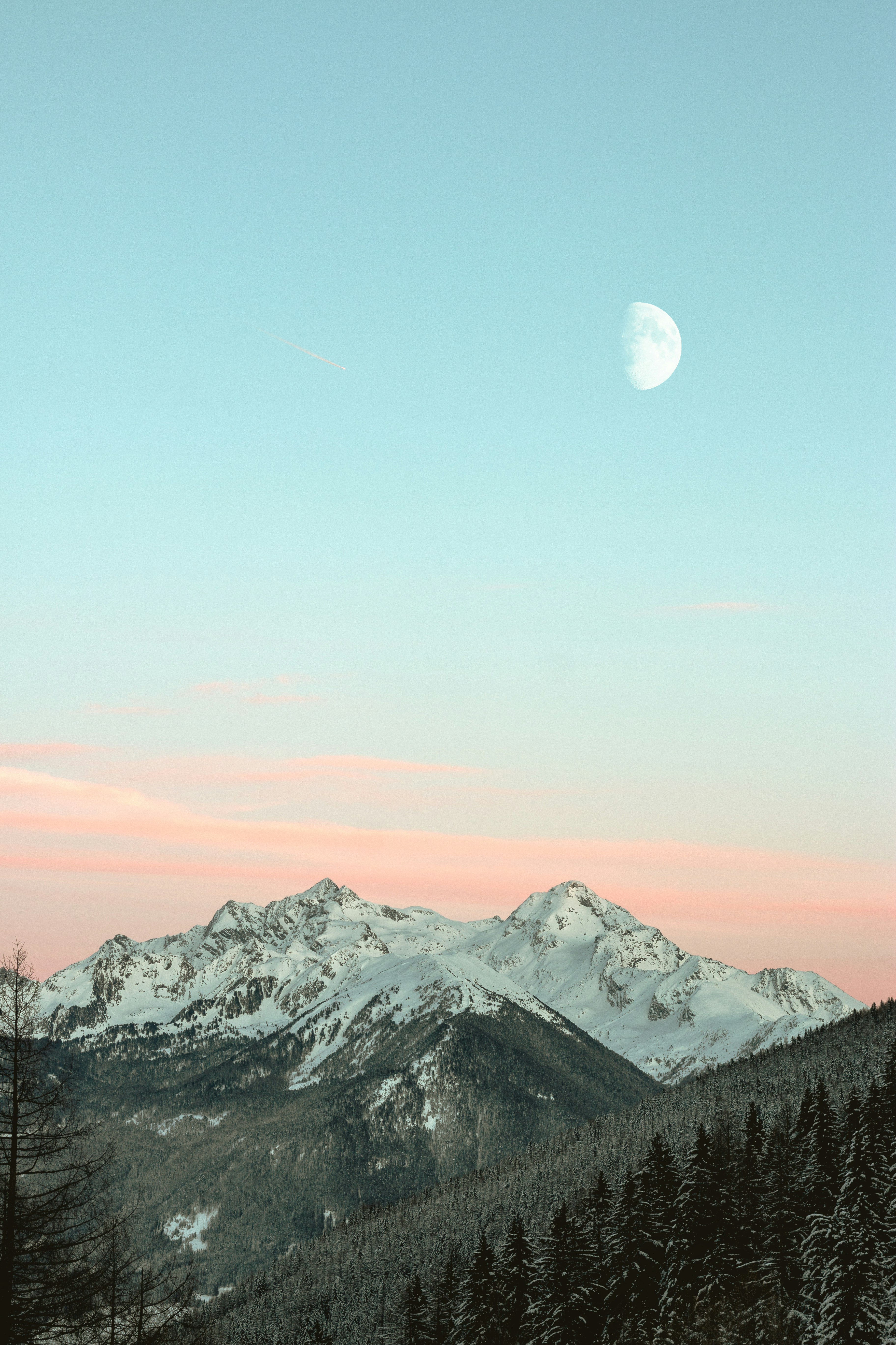 bird's eye view of mountain peaks under blue sky